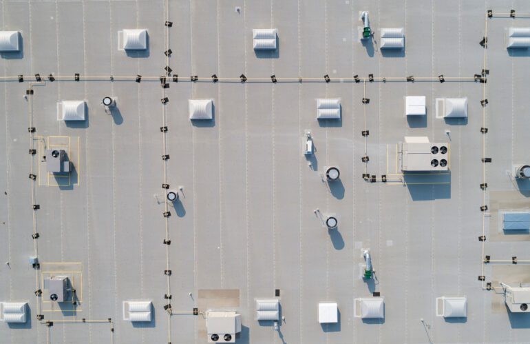 looking down on a commercial rooftop showing skylights and HVAC equipment