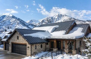 A standing seam metal roof with snow guards installed above the entry on a northern Utah home.
